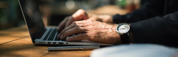 Laptop, watch, and hands