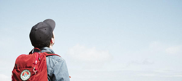 student wearing backpack looking at sky (c) Matese Fields 233175 unsplash